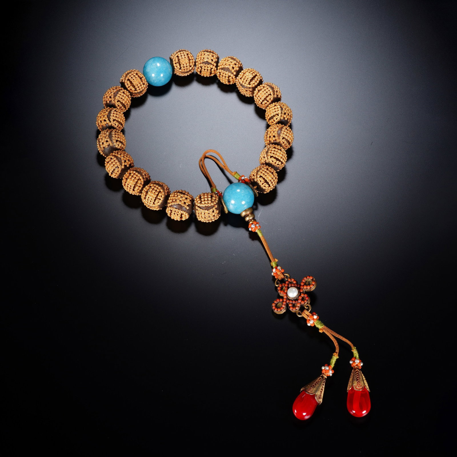 A CHINESE AGARWOOD SHOU EIGHTEEN-BEAD BRACELET: A CHINESE AGARWOOD SHOU EIGHTEEN-BEAD BRACELET This eighteen-bead prayer bracelet is strung with carved agarwood beads measuring 1.8 cm in diameter each, with a total weight of 122 grams. Each wooden 