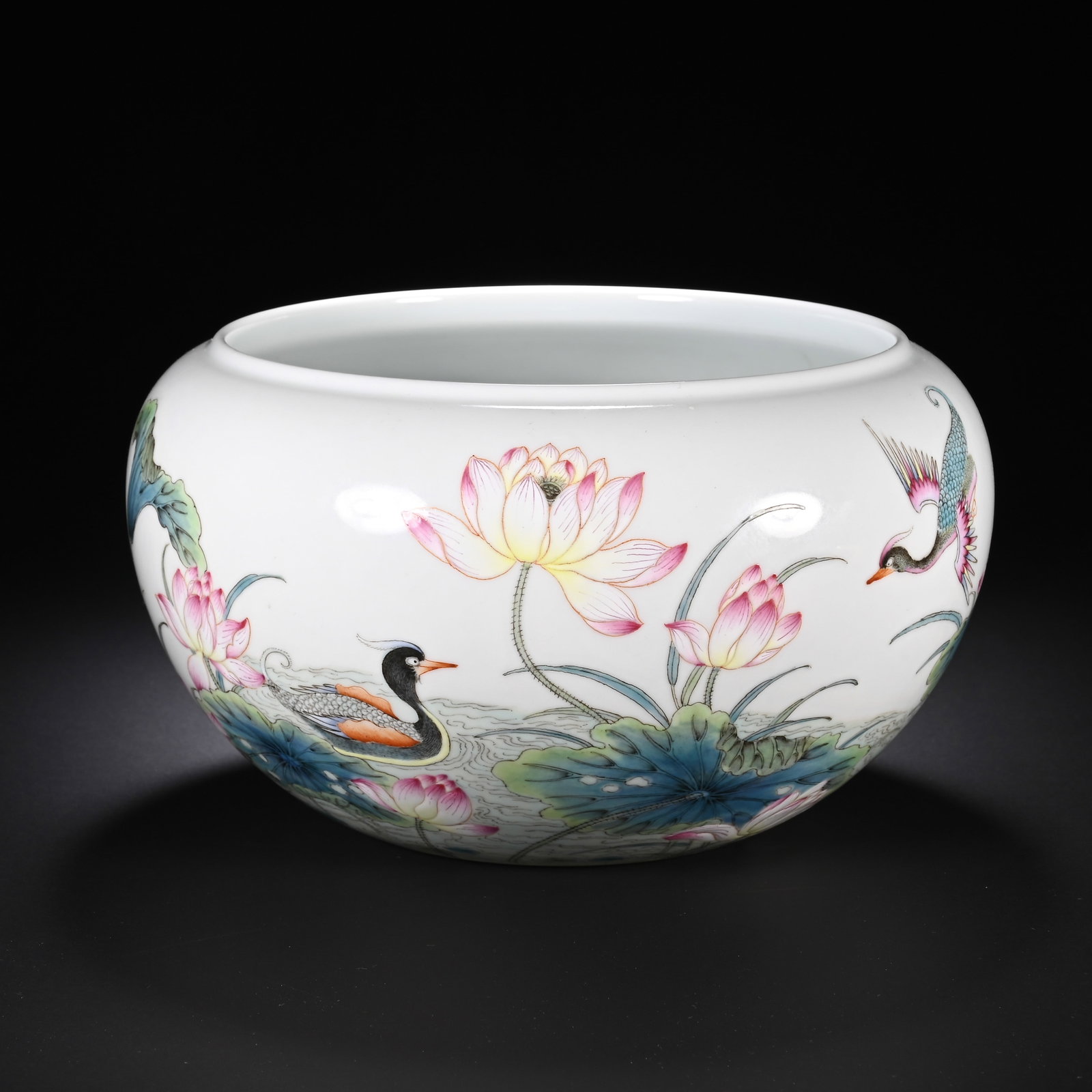A CHINESE FAMILLE ROSE LOTUS AND MANDARIN DUCK BRUSH WASHER: A CHINESE FAMILLE ROSE LOTUS AND MANDARIN DUCK BRUSH WASHER This globular literati brush washer boasts smooth white porcelain body with a wide rounded mouth and gently tapering base. Its exterior is f