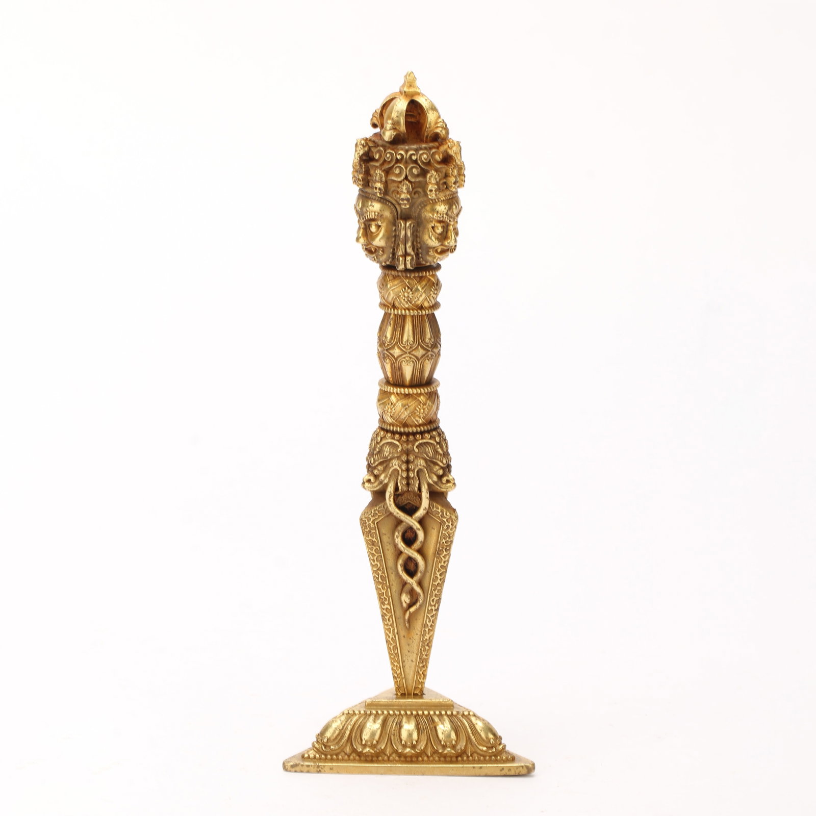 A CHINESE GILT BRONZE BUDDHIST PHURBA RITUAL DAGGER: A CHINESE GILT BRONZE BUDDHIST PHURBA RITUAL DAGGER This fully gilt bronze ceremonial phurba stands upon a square lotus pedestal decorated with detailed overlapping lotus petal moulding. The upper seg