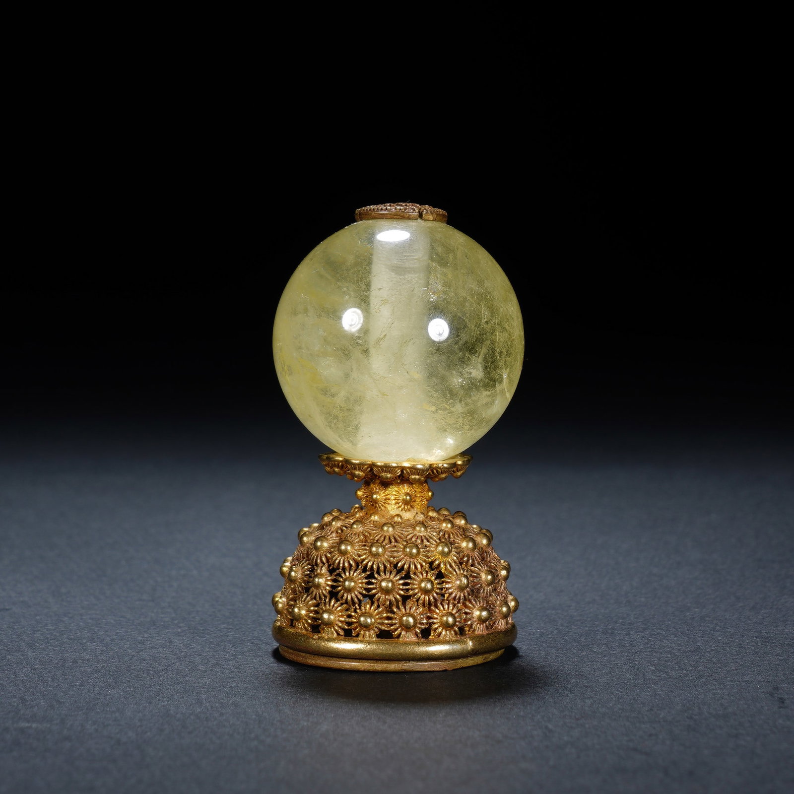 A CHINESE ROCK CRYSTAL OFFICIAL HAT FINIAL: A CHINESE ROCK CRYSTAL OFFICIAL HAT FINIAL This mandarin hat finial measures 3 cm wide and 5.5 cm tall, weighing 58 grams. At its apex sits a smooth, spherical pale yellow rock crystal orb with natura