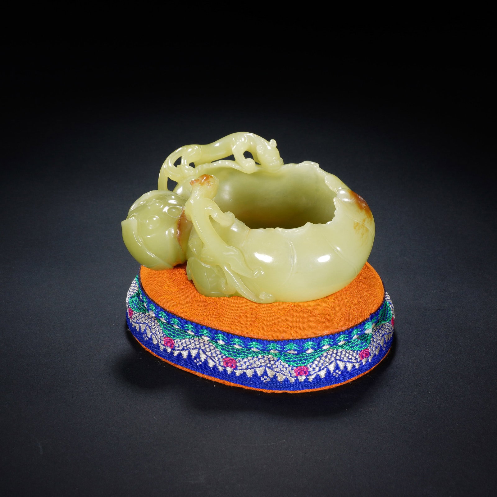 A CHINESE YELLOW JADE LOTUS BRUSH WASHER: A CHINESE YELLOW JADE LOTUS BRUSH WASHER This literati jade brush washer measures 10 cm wide, 9 cm deep and 5 cm tall, weighing 219 grams. Carved from soft pale yellow nephrite naturally marked with w