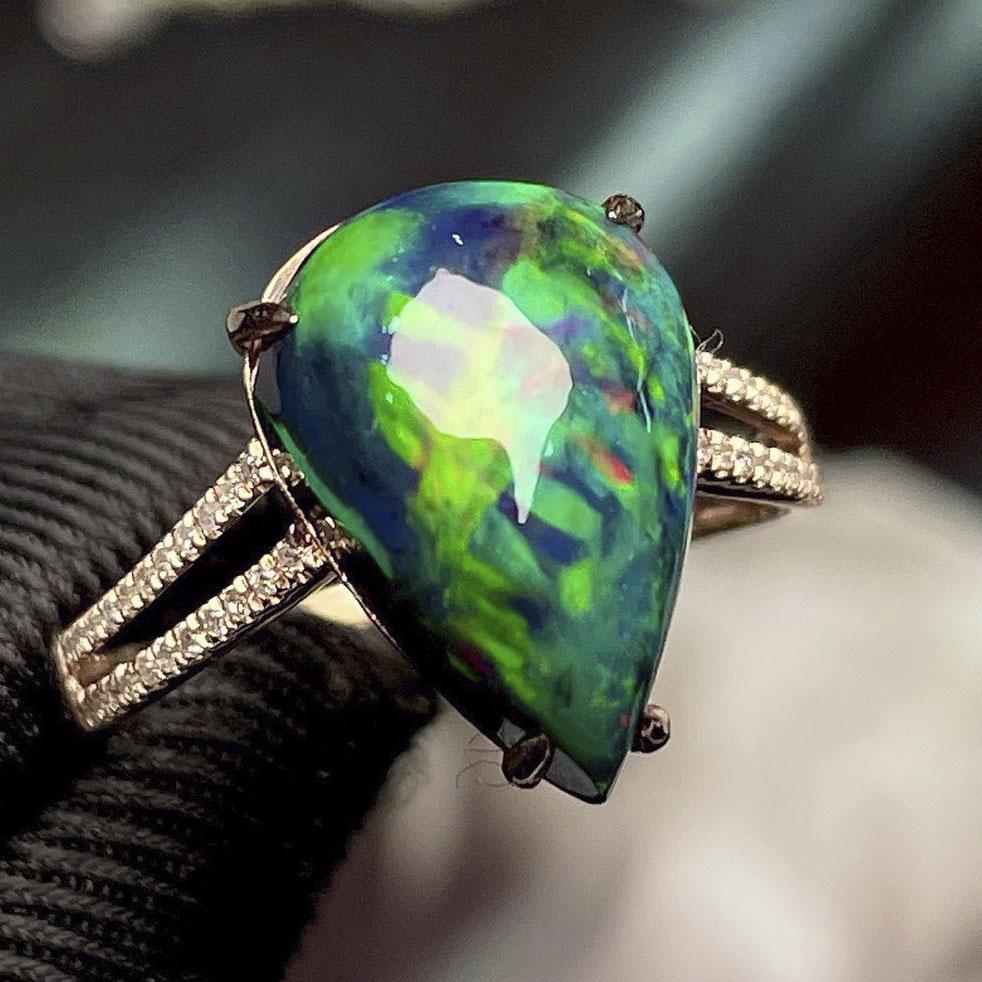 14K Rose Gold 4.05CT Black Opal & Diamond Ring with Certificate: Ref:202251091 Gold Content:14K Rose Gold For people:Women Ring Size:7.25 US Main Gemstone: Opal Number of stones:1 Shape:Pear Carat Weight:4.05ct Gemstone Size:13*9.5mm Color:Black Cut Grade:G