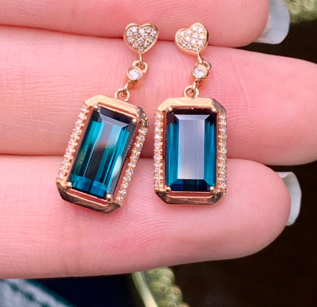 14K Rose Gold 5.5 CT Tourmaline & Diamond Earrings: Ref:2022701133 Gold Content:14K Rose Gold For people:Women Total Item Weight:4.5grams Main Stone:Tourmaline Number of stones:2 Shape:Emerald Carat Total Wt:5.5ct Color:Blue Cut Grade:G Adjacen