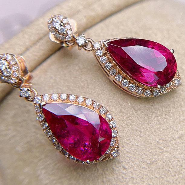 14K Rose Gold 2.95 CT Tourmaline & Diamond Earrings: Ref:2022701225 Gold Content:14K Rose Gold For people:Women Total Item Weight:3.8grams Main Stone:Tourmaline Number of stones:2 Shape:Pear Carat Total Wt:2.95ct Color:Red Cut Grade:G Adjacent G