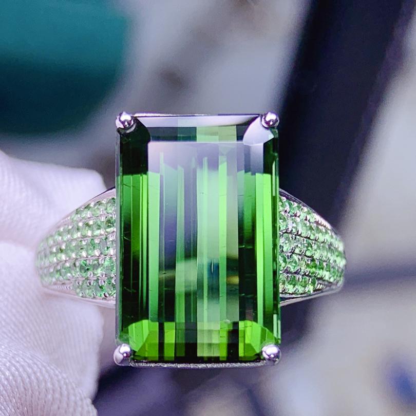 14K White Gold 9.62 CT Tourmaline & Tsavorite Ring: Ref:2022928335 Gold Content:14K White Gold For people:Women Ring Size:7.25us Main Stone:Tourmaline Number of stones:1 Shape:Emerald Carat Total Wt:9.62ct Color:Green Cut Grade:G Adjacent Gemst