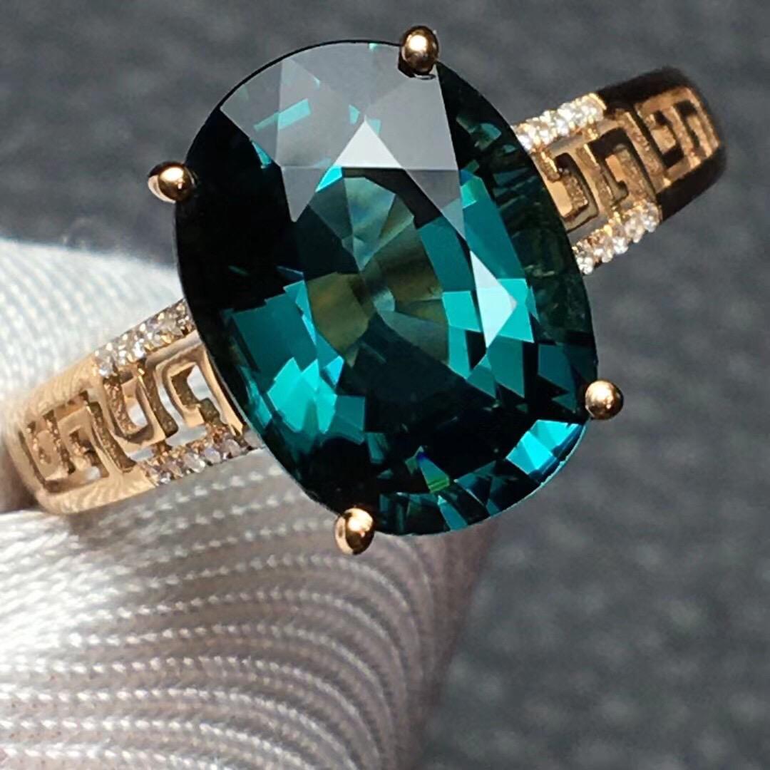 14K Rose Gold 2.9 CT Tourmaline & Diamond Ring: Ref:1112058 Gold Content:14K Rose Gold For people:Women Total Item Weight:1.75grams Ring Size:7.25us Main Stone:Tourmaline Number of stones:1 Shape:Oval Carat Total Wt:2.9ct Color:Blue Cut Grade:G