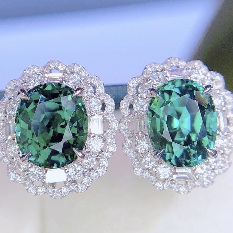 14K White Gold 8.24 CTW Tourmaline & Diamond Earrings: Ref:23213145 Gold Content:14K White Gold For people:Women Main Stone:Tourmaline Number of stones:2 Shape:Oval Carat Total Wt:6.48ct Color:Green Cut Grade:G Adjacent Gemstone 2 : Diamond Shape: