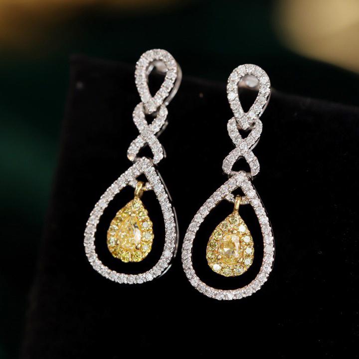 14K GOLD 0.5 CT YELLOW DIAMOND & DIAMOND EARRINGS: Ref:23402232 Gold Content:14K Gold Main Gemstone:Yellow Diamond Number of stones:2 Shape:Pear Carat Weight:0.5ct Color:Yellow Cut Grade:G Adjacent Gemstone 2 : Diamond Shape:Round Clarity Grad