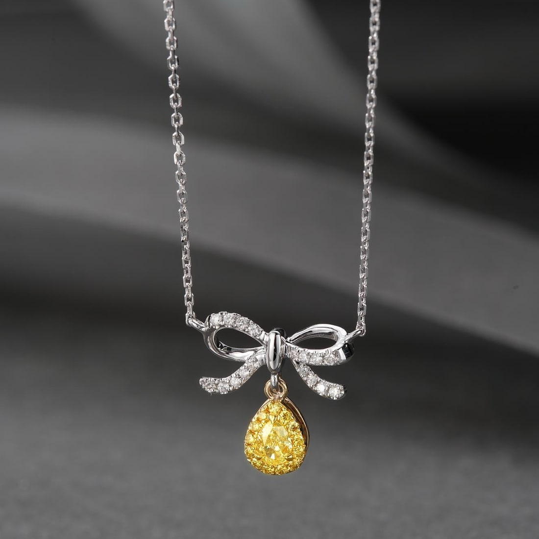 14K GOLD 0.23 CTW NATURAL YELLOW DIAMOND & DIAMOND NECKLACE: Ref:230798430 Gold Content:14K Gold Main Gemstone:Yellow Diamond Shape:Pear Carat Weight:0.13ct Color:Yellow Treatment:Natural Adjacent Gemstone 2 : Diamond Shape:Round Carat Weight:0.10ct Cl