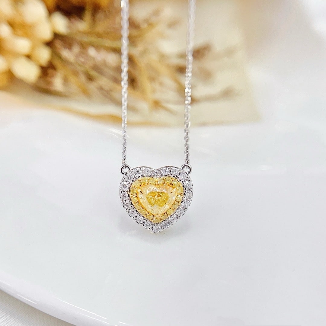 GIA CERTIFIED 14K GOLD 0.83 CTW NATURAL YELLOW DIAMOND & DIAMOND NECKLACE: Ref:230838460 Gold Content:14K Gold Main Gemstone:Yellow Diamond Certified:GIA Number of stones:1 Shape:Heart Carat Weight:0.61ct Clarity Grade:VVS2 Color:Yellow Treatment:Natural Saturability:Fancy