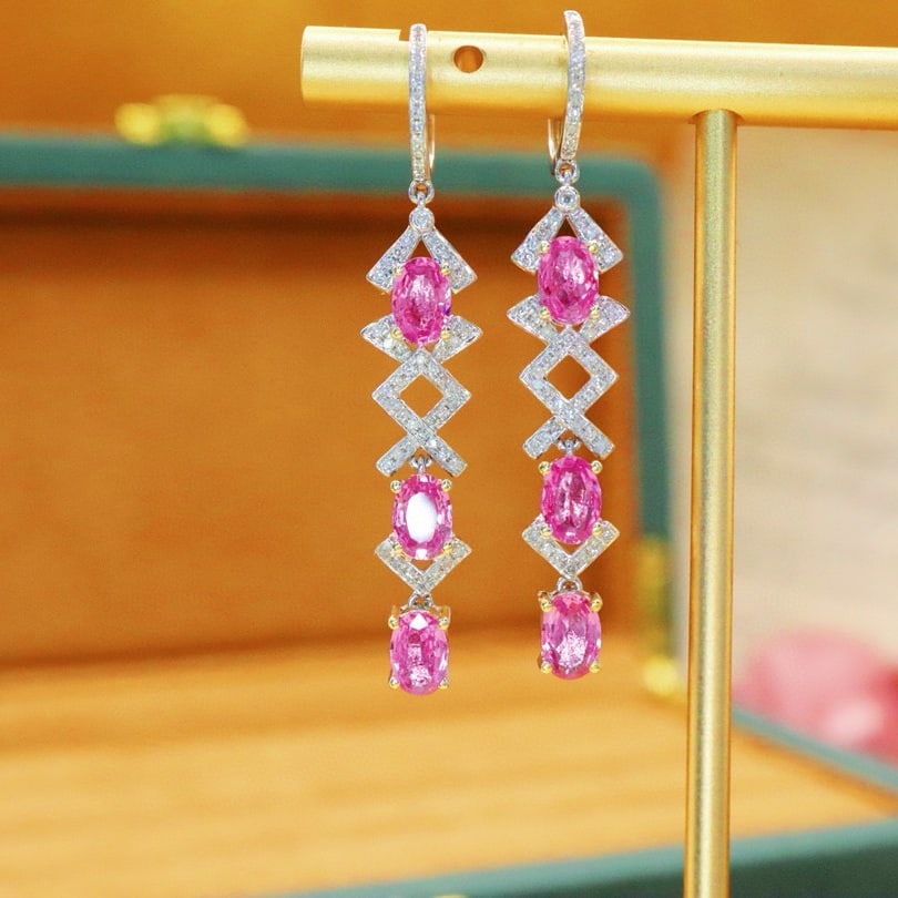 14K GOLD 3.43 CTW NATURAL PADPARADSCHA SAPPHIRE & DIAMOND EARRINGS: Ref:230910297 Gold Content:14K Gold Main Gemstone:Padparadscha Sapphire Shape:Oval Carat Weight:3.10ct Color:Orangish Pink Treatment:Natural Adjacent Gemstone 2 : Diamond Number of stones:110 Shap