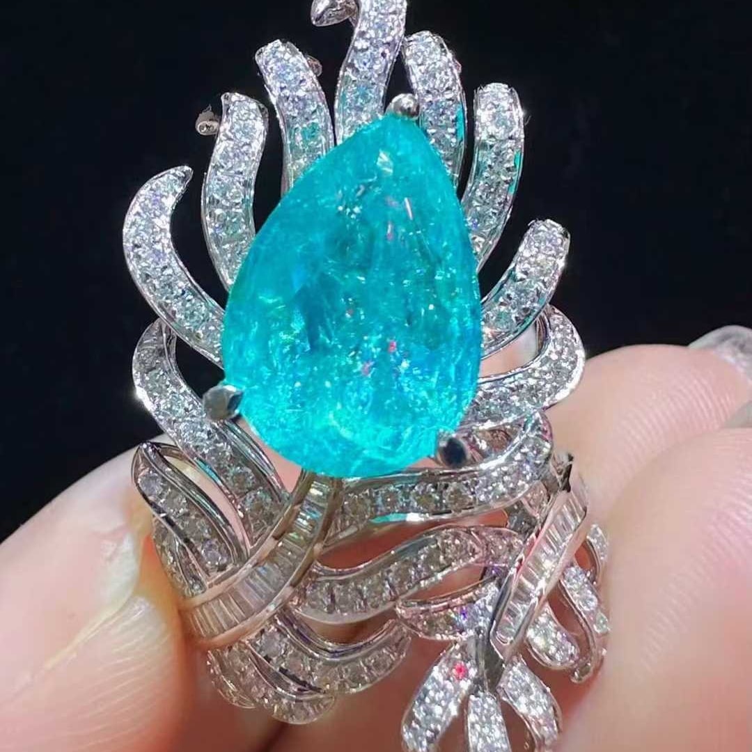 14k Gold 6.43 Ctw Natural Paraiba Tourmaline & Diamond Ring: Ref:231105090 // gold content:14k gold // ring size:7. 25us // // main gemstone:paraiba tourmaline // shape:pear // carat weight:5. 66ct // color:blue // treatment:natural // // adjacent gemstone