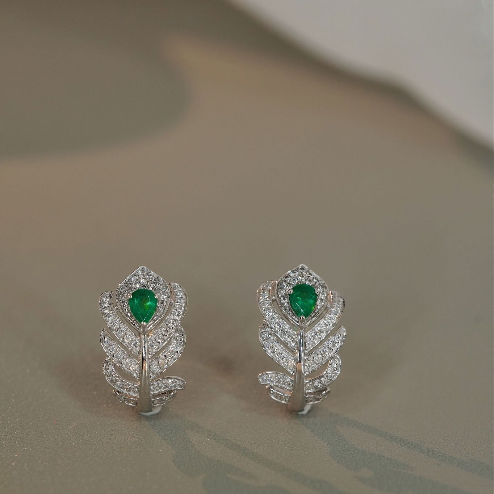 14k Gold 0.7 Ctw Vivid Green Natural Emerald & Diamond Earrings: Ref:231106171 // gold content:14k gold // main gemstone:emerald // shape:pear // carat weight:0. 3ct // color:vivid green // treatment:natural // // adjacent gemstone 2 : diamond // shape:round //