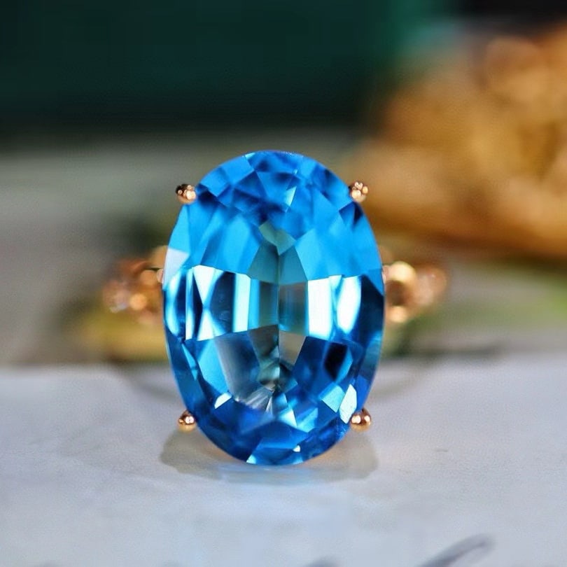 14k Gold 6.95 Ctw Natural Topaz & Diamond Ring: Ref:231115054 // gold content:14k gold // ring size:7. 25us // // main gemstone:topaz // shape:oval // carat weight:6. 9ct // color:blue // treatment:natural // // adjacent gemstone 2 : diamond // num