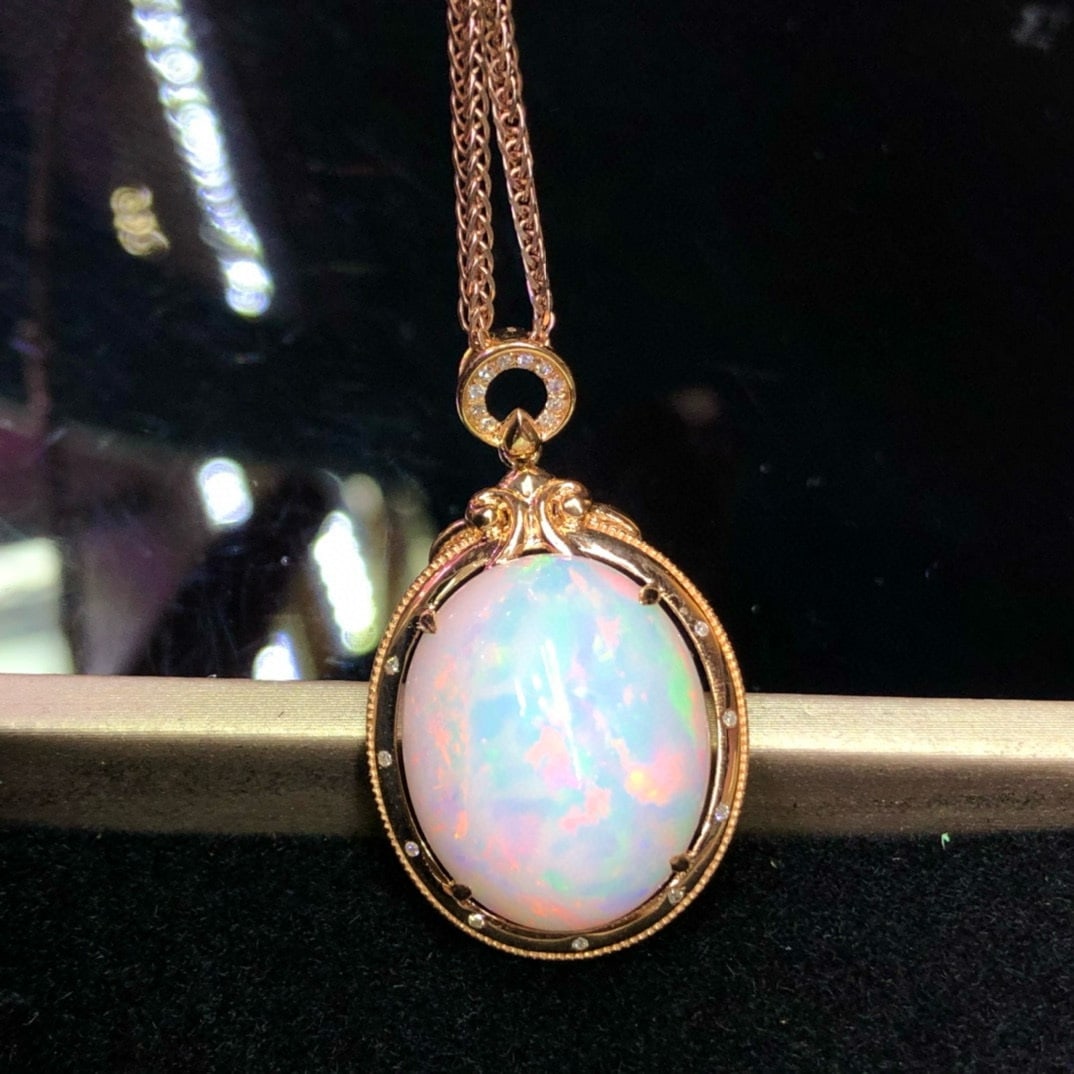 14k Gold 12.85 Ct Natural Opal & Diamond Pendant( Without Chain ): Ref:231115189 // gold content:14k gold // main gemstone:opal // shape:oval // carat weight:12. 85ct // color:color // treatment:natural // // adjacent gemstone 2 : diamond // number of stones:19 //