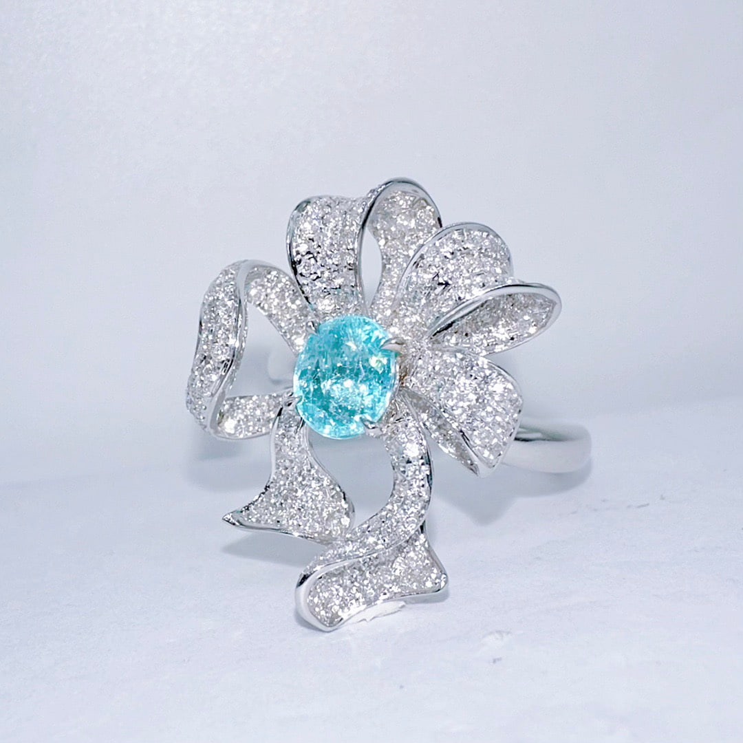 14k Gold 1.36 Ctw Natural Paraiba Tourmaline & Diamond Ring: Ref:231120072 // gold content:14k gold // ring size:7. 25us // // main gemstone:paraiba tourmaline // shape:oval // carat weight:0. 70ct // color:blue // treatment:natural // // adjacent gemstone 2 :