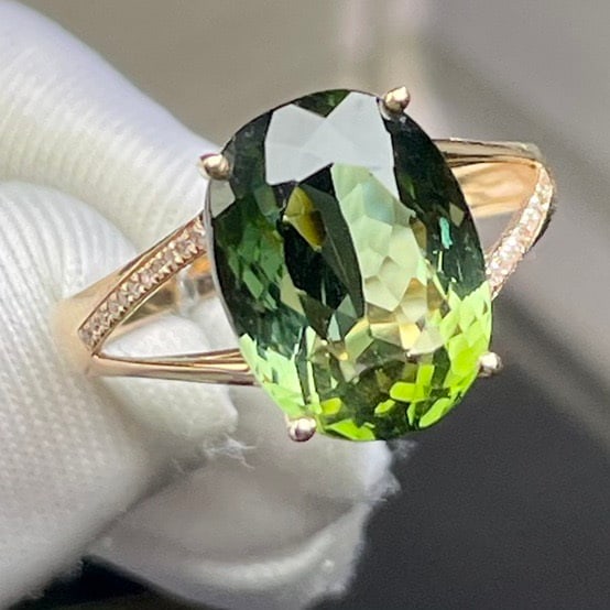 14k Gold 6.25 Ct Natural Tourmaline & Diamond Ring: Ref:231120362 // gold content:14k gold // ring size:7. 25us // // main gemstone:tourmaline // shape:oval // carat weight:6. 25ct // color:green // treatment:natural // // adjacent gemstone 2 :