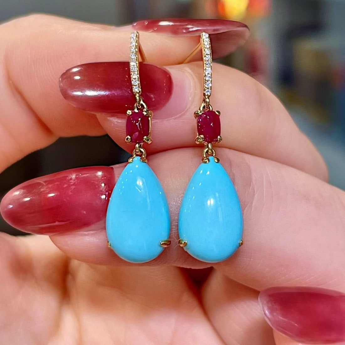 14k Gold 5.41 Ctw Natural Blue Turquoise & Ruby Earrings: Ref:231117020 // gold content:14k gold // main gemstone:blue turquoise // shape:pear // carat weight:4. 98ct // color:blue // treatment:natural // // adjacent gemstone 2 : ruby // shape:oval //