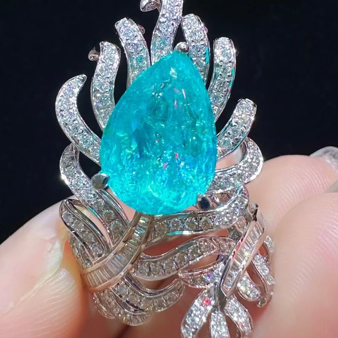 14k Gold 6.43 Ctw Natural Paraiba Tourmaline & Diamond Ring: Ref:231117143 // gold content:14k gold // ring size:7. 25us // // main gemstone:paraiba tourmaline // shape:pear // carat weight:5. 66ct // color:blue // treatment:natural // // adjacent gemstone