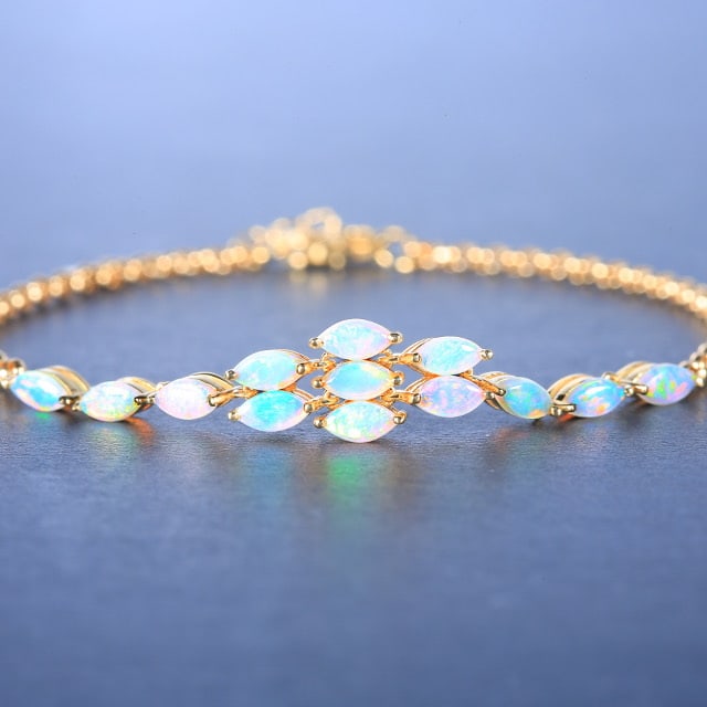 14k Gold 1.25 Ct Natural Opal Bracelet: Ref:230976317 // gold content:14k gold // main gemstone:opal // shape:marquise // carat weight:1. 25ct // color:white // treatment:natural // Low Estimate: 2600Condition: NewHigh Estimate: 4000
