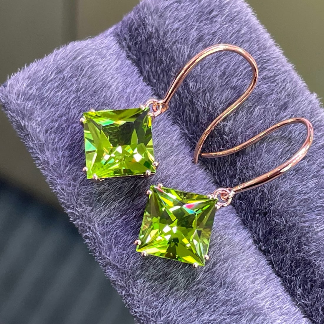 14k Gold 5.25 Ct Natural Peridot Earrings: Ref:231133152 // gold content:14k gold // main gemstone:peridot // shape:princess // carat weight:5. 25ct // color:green // treatment:natural // Low Estimate: 1200 Condition: New High Estimate: 1800