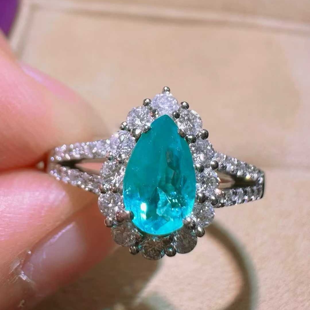 14k Gold 0.95 Ctw Natural Paraiba Tourmaline & Diamond Ring: Ref:231133197 // gold content:14k gold // ring size:7. 25us // // main gemstone:paraiba tourmaline // shape:pear // carat weight:0. 53ct // color:blue // treatment:natural // // adjacent gemstone