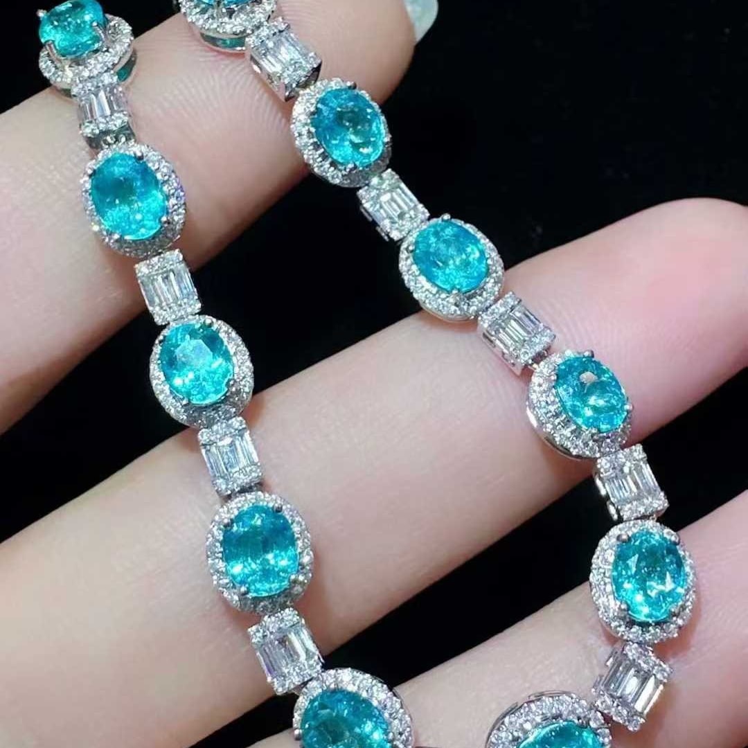 14k Gold 5.89 Ctw Natural Paraiba Tourmaline & Diamond Bracelet: Ref:231129103 // gold content:14k gold // main gemstone:paraiba tourmaline // shape:oval // carat weight:4. 11ct // color:blue // treatment:natural // // adjacent gemstone 2 : diamond //