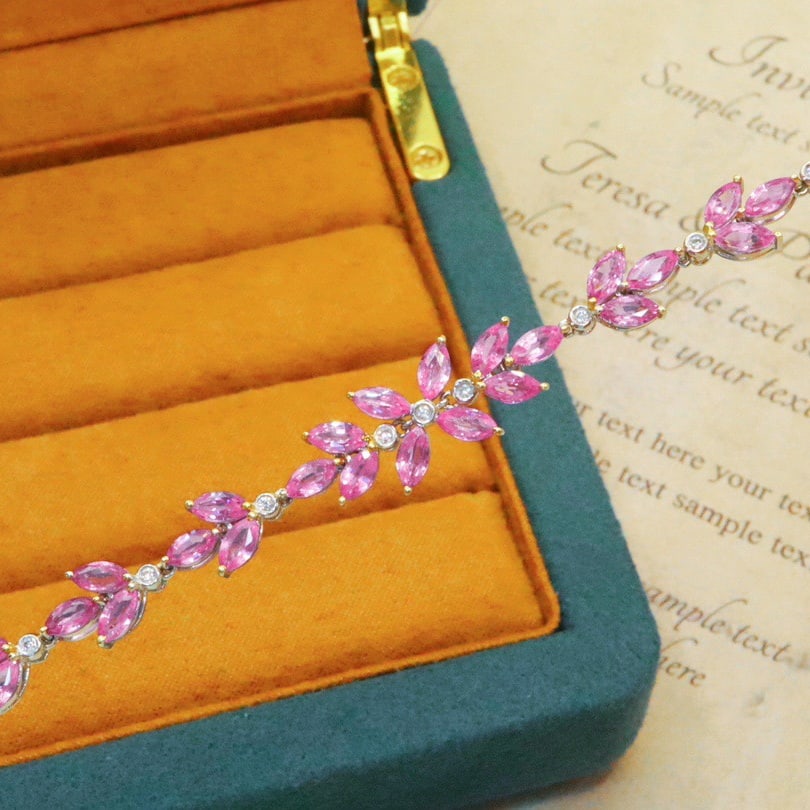 14k Gold 5.19 Ctw Natural Padparadscha Sapphire & Diamond Bracelet: Ref:231128355 // gold content:14k gold // main gemstone:padparadscha sapphire // shape:marquise // carat weight:5. 10ct // color:orangish pink // treatment:natural // // adjacent gemstone 2 :