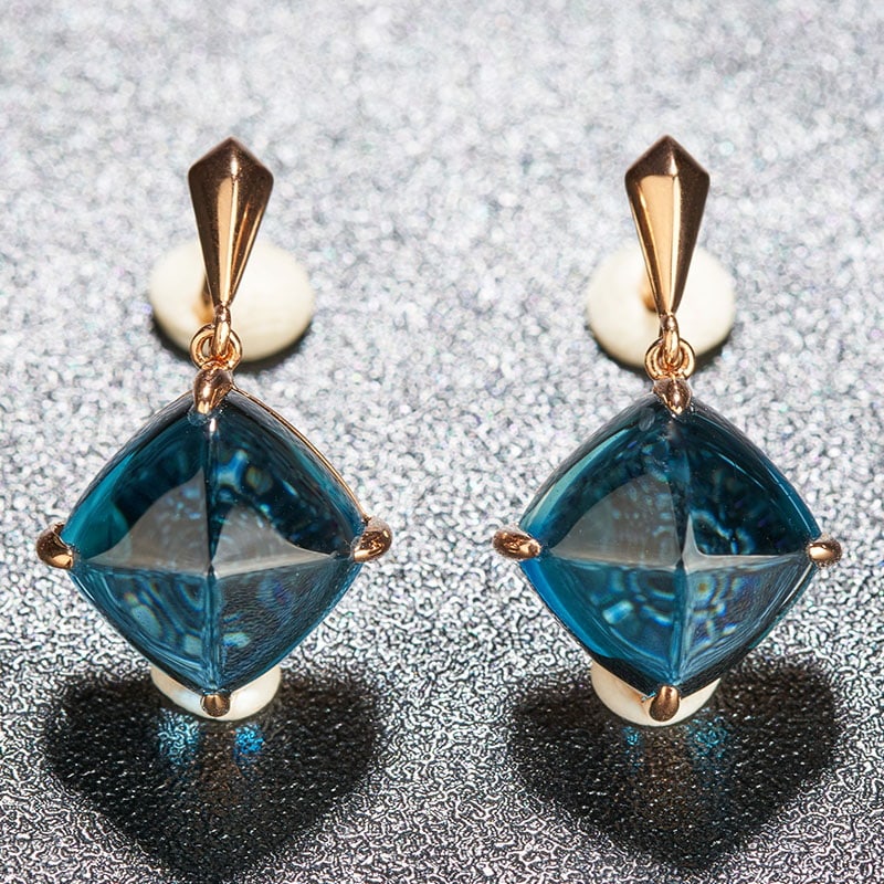 14k Gold 10.5 Ct Natural Topaz Earrings: Ref:230939241 // gold content:14k gold // main gemstone:topaz // shape:suger-loaf // carat weight:10. 5ct // color:blue // treatment:natural // Condition: New Low Estimate: 1300.00 High Estimate: 200