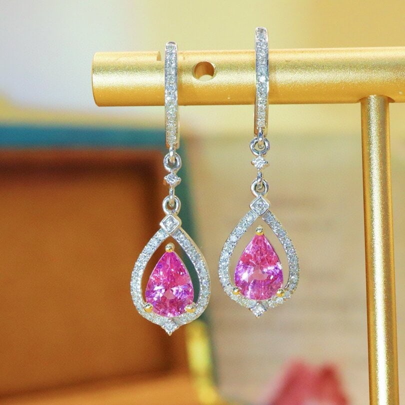 14k Gold 2.22 Ctw Natural Padparadscha Sapphire & Diamond Earrings: Ref:230940349 // gold content:14k gold // main gemstone:padparadscha sapphire // shape:pear // carat weight:1. 96ct // color:orangish pink // treatment:natural // // adjacent gemstone 2 : diamond