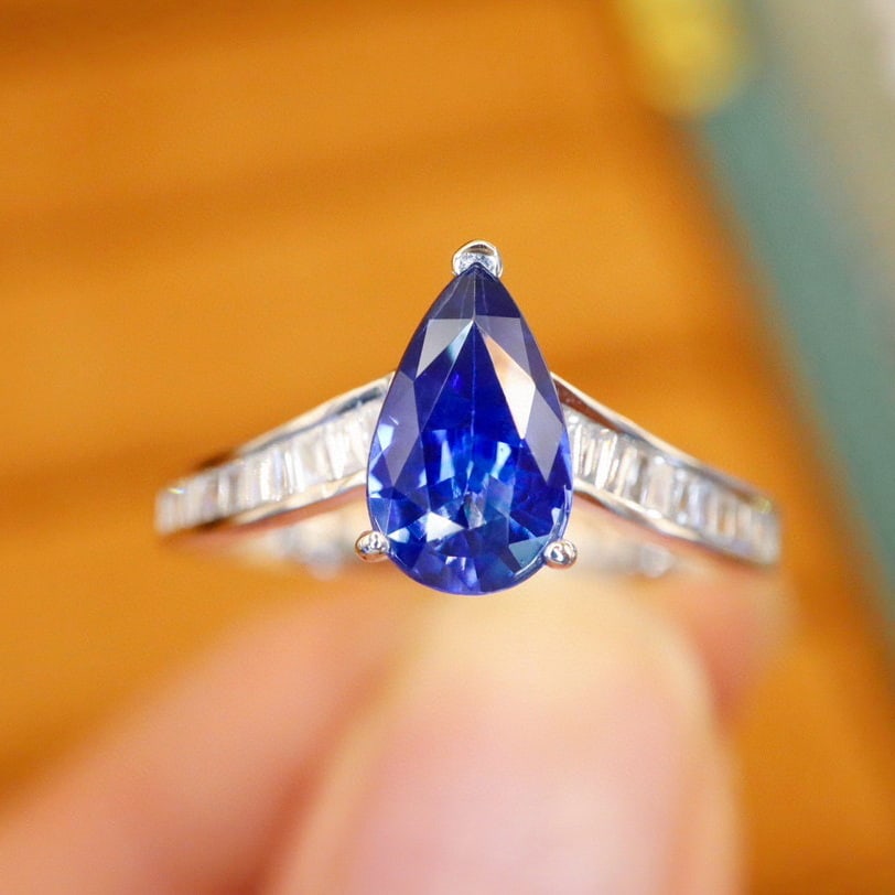 14k Gold 1.30 Ctw Natural Sapphire & Diamond Ring: Ref:230940413 // gold content:14k gold // ring size:7. 25us // // main gemstone:sapphire // shape:pear // carat weight:1. 10ct // color:royal blue // treatment:natural // // adjacent gemstone 2 :