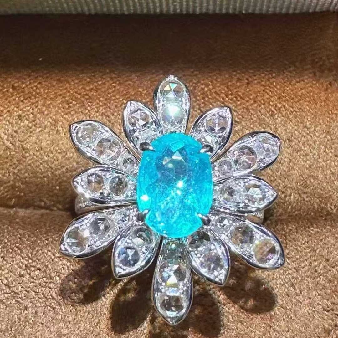 14k Gold 2.31 Ctw Natural Paraiba Tourmaline & Diamond Ring: Ref:231125118 // gold content:14k gold // ring size:7. 25us // // main gemstone:paraiba tourmaline // shape:oval // carat weight:1. 47ct // color:blue // treatment:natural // // adjacent gemstone 2 :