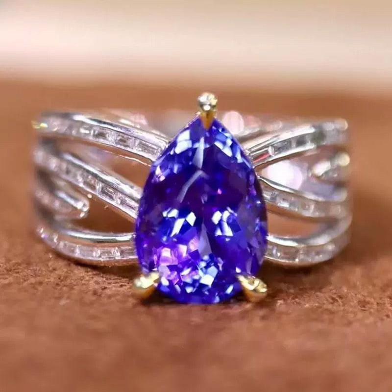 14k Gold 3.03 Ctw Natural Tanzanite & Diamond Ring: Ref:231126283 // gold content:14k gold // ring size:7. 25us // // main gemstone:tanzanite // shape:pear // carat weight:2. 60ct // color:blue // treatment:natural // // adjacent gemstone 2 : diamond /