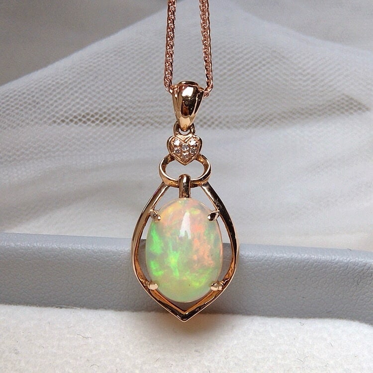14k Gold 2.80 Ct Natural Opal & Diamond Pendant( Without Chain ): Ref:231135216 // gold content:14k gold // main gemstone:opal // shape:oval // carat weight:2. 80ct // color:color // treatment:natural // // adjacent gemstone 2 : diamond // number of stones:6 //
