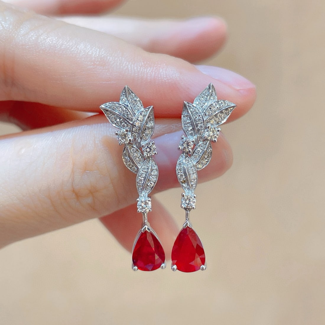 14k Gold 2.47 Ctw Natural Ruby & Diamond Earrings: Ref:231121108 // gold content:14k gold // main gemstone:ruby // shape:pear // carat weight:1. 94ct // color:red // treatment:natural // // adjacent gemstone 2 : diamond // shape:round // carat weight: