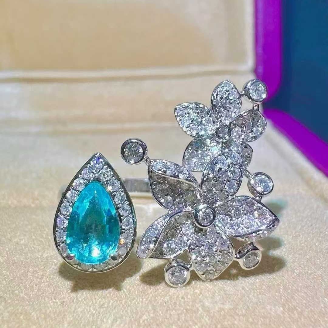 14k Gold 1.08 Ctw Natural Paraiba Tourmaline & Diamond Ring: Ref:231121224 // gold content:14k gold // ring size:7. 25us // // main gemstone:paraiba tourmaline // shape:pear // carat weight:0. 47ct // color:blue // treatment:natural // // adjacent gemstone 2 :