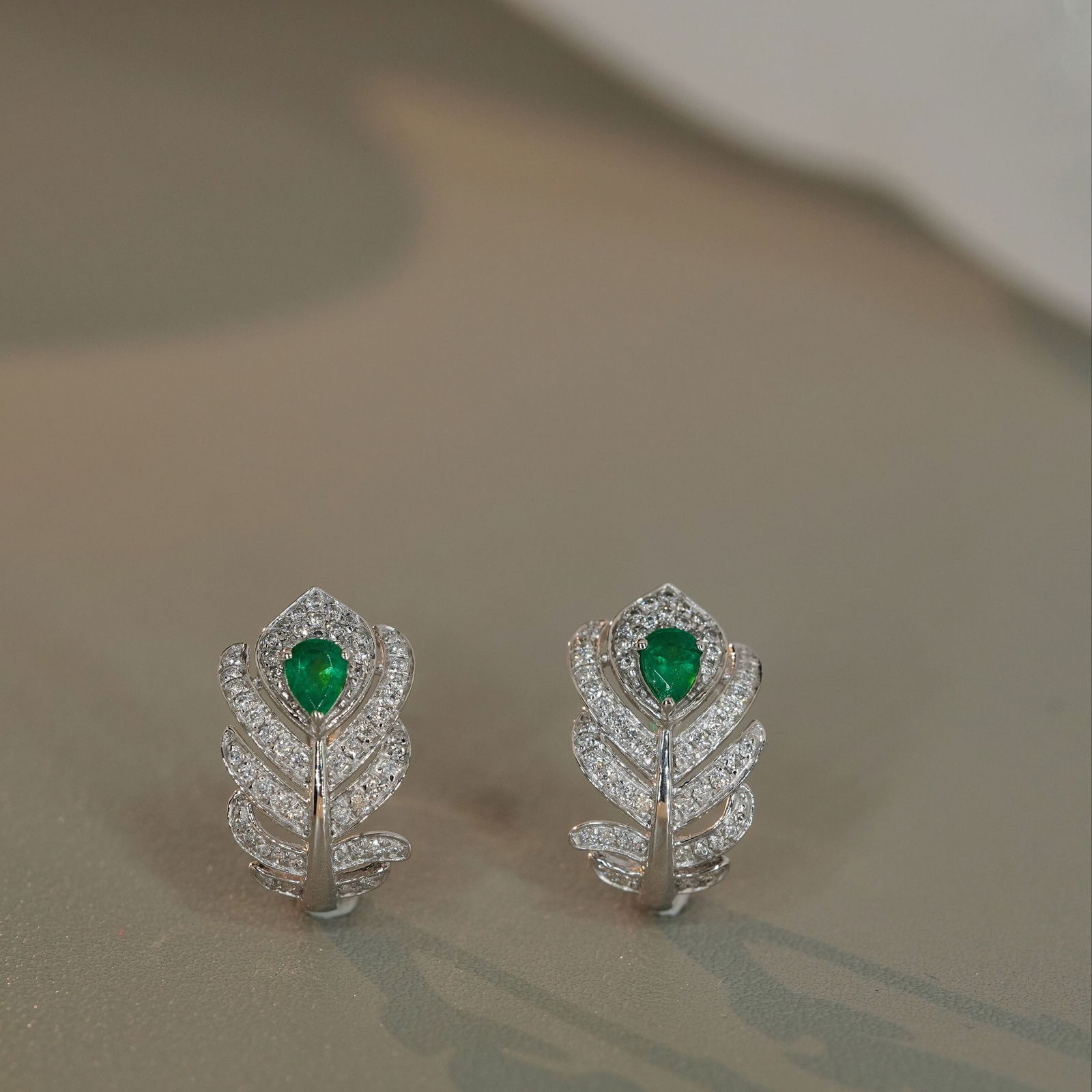 14k Gold 0.7 Ctw Vivid Green Natural Emerald & Diamond Earrings: Ref:231122161 // gold content:14k gold // main gemstone:emerald // shape:pear // carat weight:0. 3ct // color:vivid green // treatment:natural // // adjacent gemstone 2 : diamond // shape:round // car