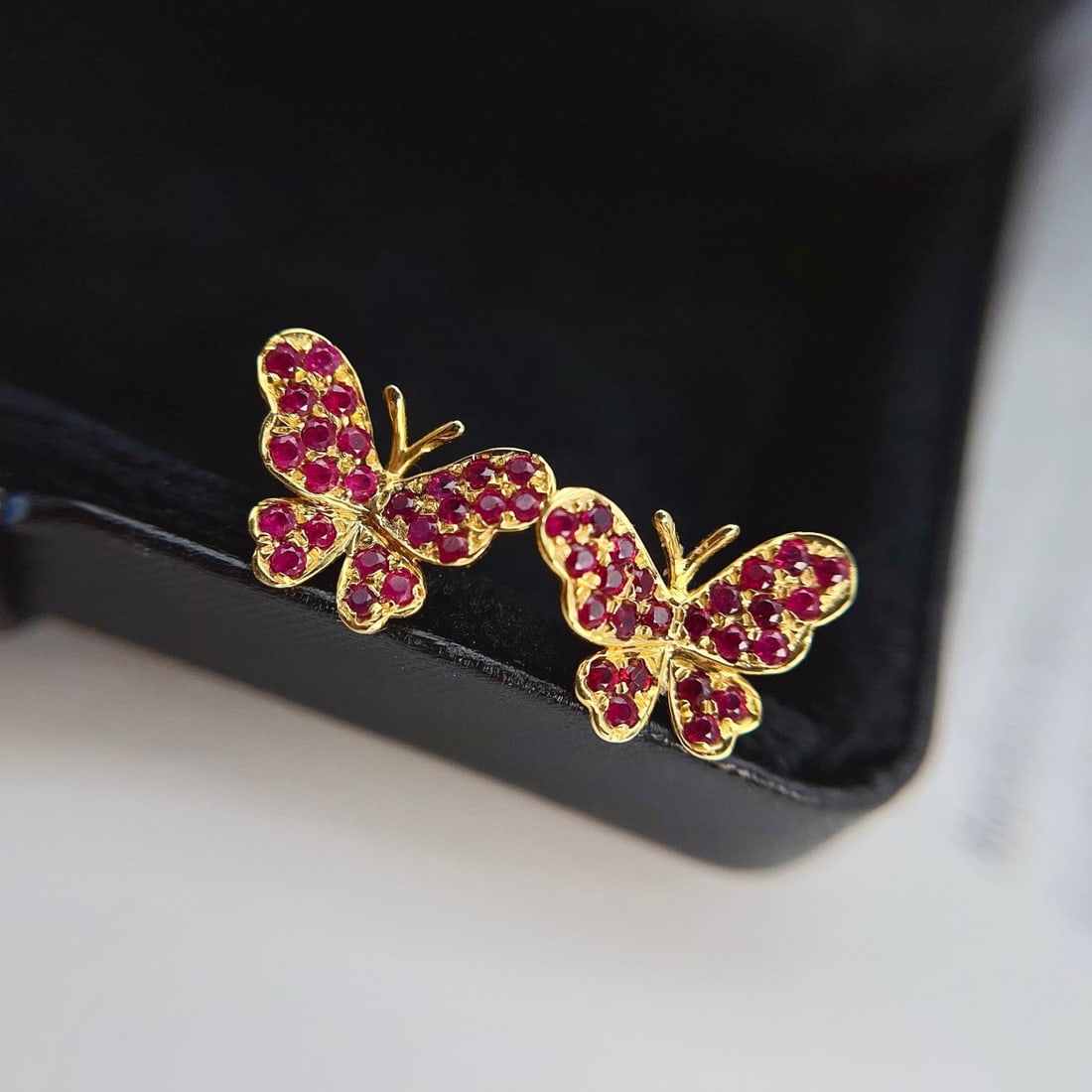 14k Gold 1.00 Ct Natural Ruby & Butterfly Earrings: Ref:231122320 // gold content:14k gold // main gemstone:ruby // shape:round // carat weight:1. 00ct // color:red // treatment:natural // cut grade:g // Condition: NewLow Estimate: 1900.00High