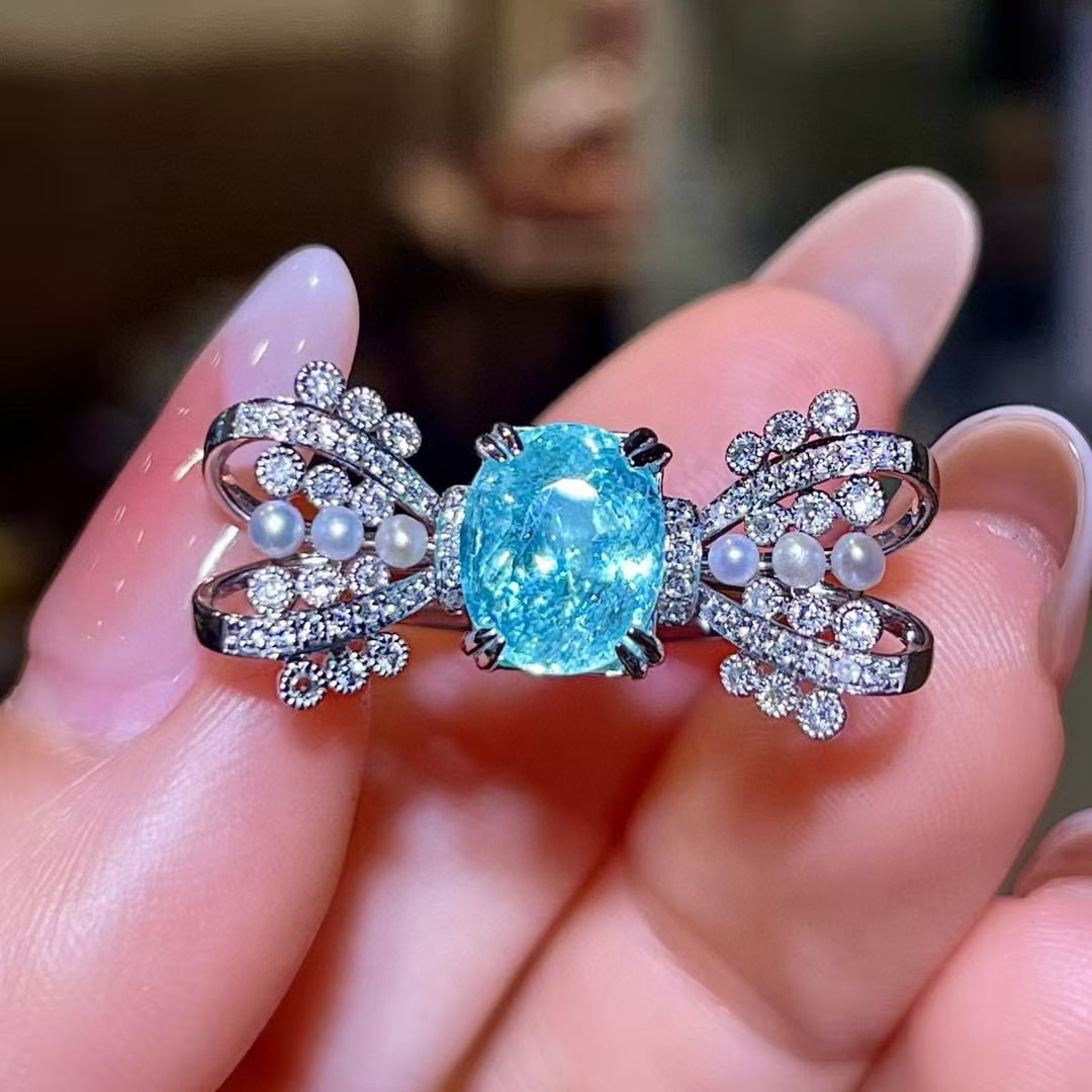 14k Gold 2.48 Ctw Natural Paraiba Tourmaline & Diamond Ring: Ref:230968031 // gold content:14k gold // ring size:7. 25us // // main gemstone:paraiba tourmaline // shape:oval // carat weight:2. 21ct // color:neon blue // treatment:natural // // adjacent