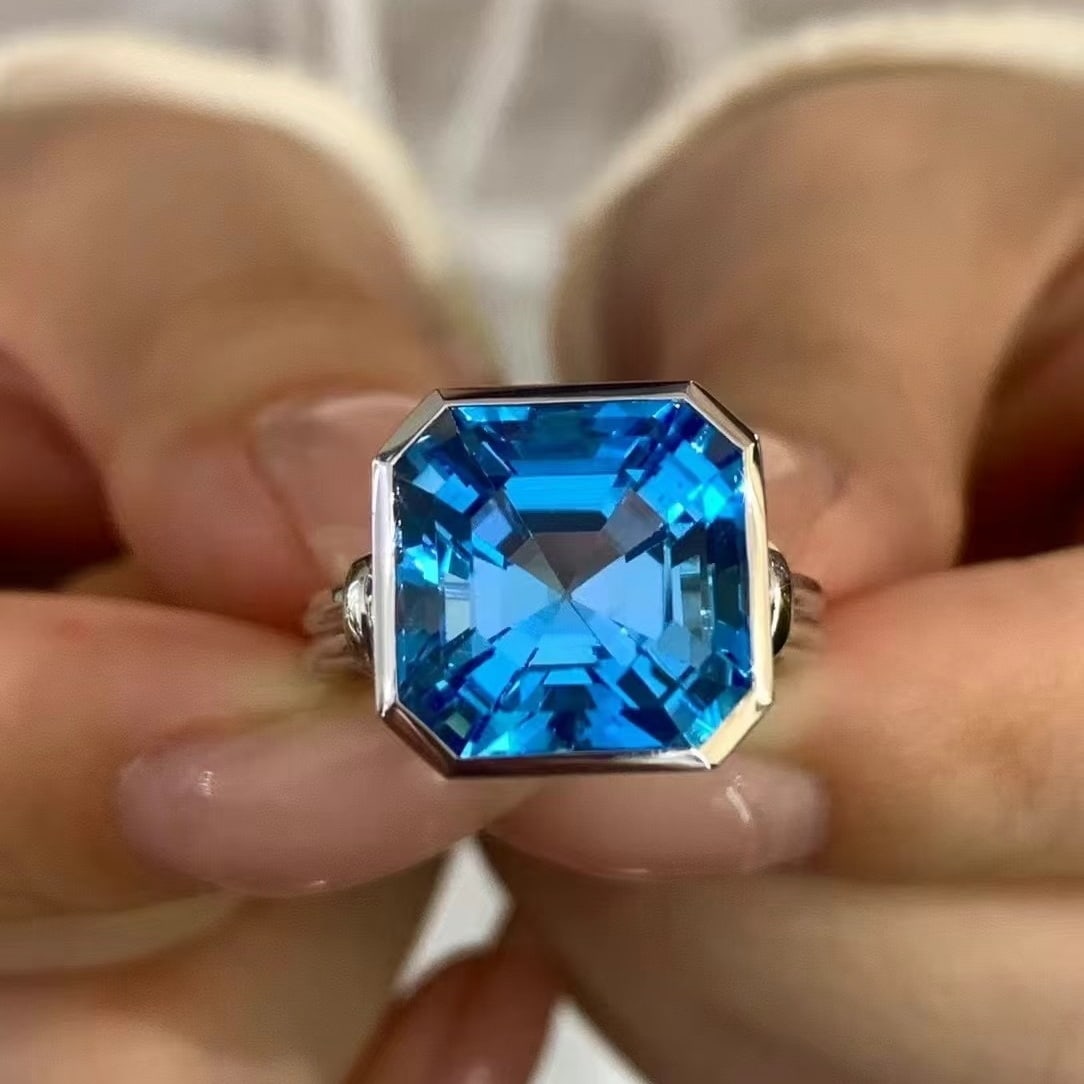 14k Gold 11.2 Ct Natural Topaz Ring: Ref:230949017 // gold content:14k gold // ring size:7. 25us // // main gemstone:topaz // shape:asscher // carat weight:11. 2ct // color:blue // treatment:natural // Condition: NewLow Estimate: