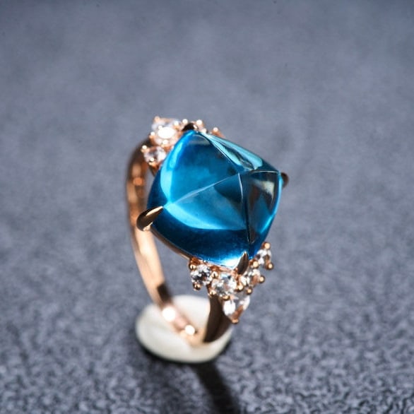 14k Gold 9.58 Ctw Natural Topaz & Sapphire Ring: Ref:231145054 // gold content:14k gold // ring size:7. 25us // // main gemstone:topaz // shape:sugar-loaf // carat weight:8. 95ct // color:blue // treatment:natural // // adjacent gemstone 2 :