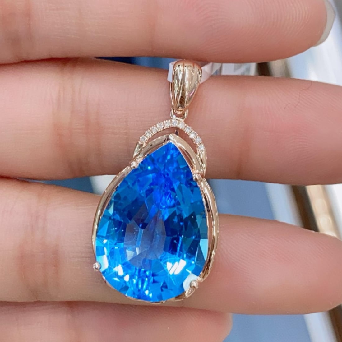 14k Gold 15.03 Ctw Natural Topaz & Diamond Pendant( Without Chain ): Ref:231145240 // gold content:14k gold // main gemstone:topaz // shape:pear // carat weight:15ct // color:blue // treatment:natural // // adjacent gemstone 2 : diamond // number of stones:11 //