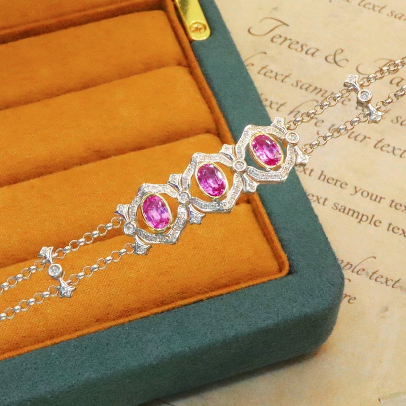 14k Gold 1.94 Ctw Natural Padparadscha Sapphire & Diamond Bracelet: Ref:230976344 // gold content:14k gold // main gemstone:padparadscha sapphire // shape:oval // carat weight:1. 63ct // color:orangish pink // treatment:natural // // adjacent gemstone 2 : diamond //