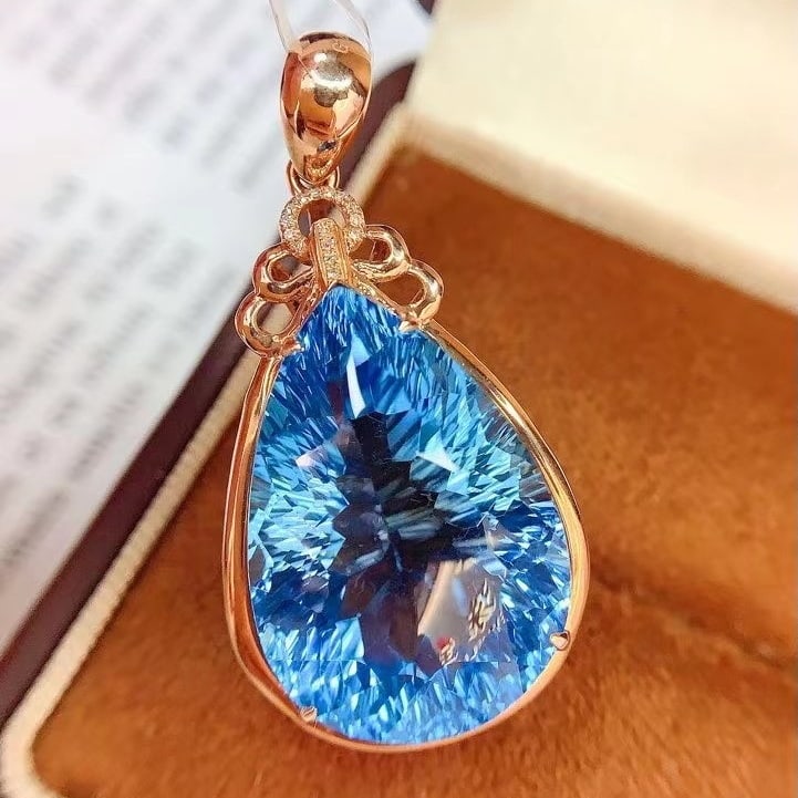 14k Gold 34 Ct Natural Topaz & Diamond Pendant( Without Chain ): Ref:230982027 / / gold content:14k gold / / main gemstone:topaz / / shape:pear / / carat weight:34ct / / color:blue / / treatment:natural / / / / adjacent gemstone 2 : diamond / / number of stones:15