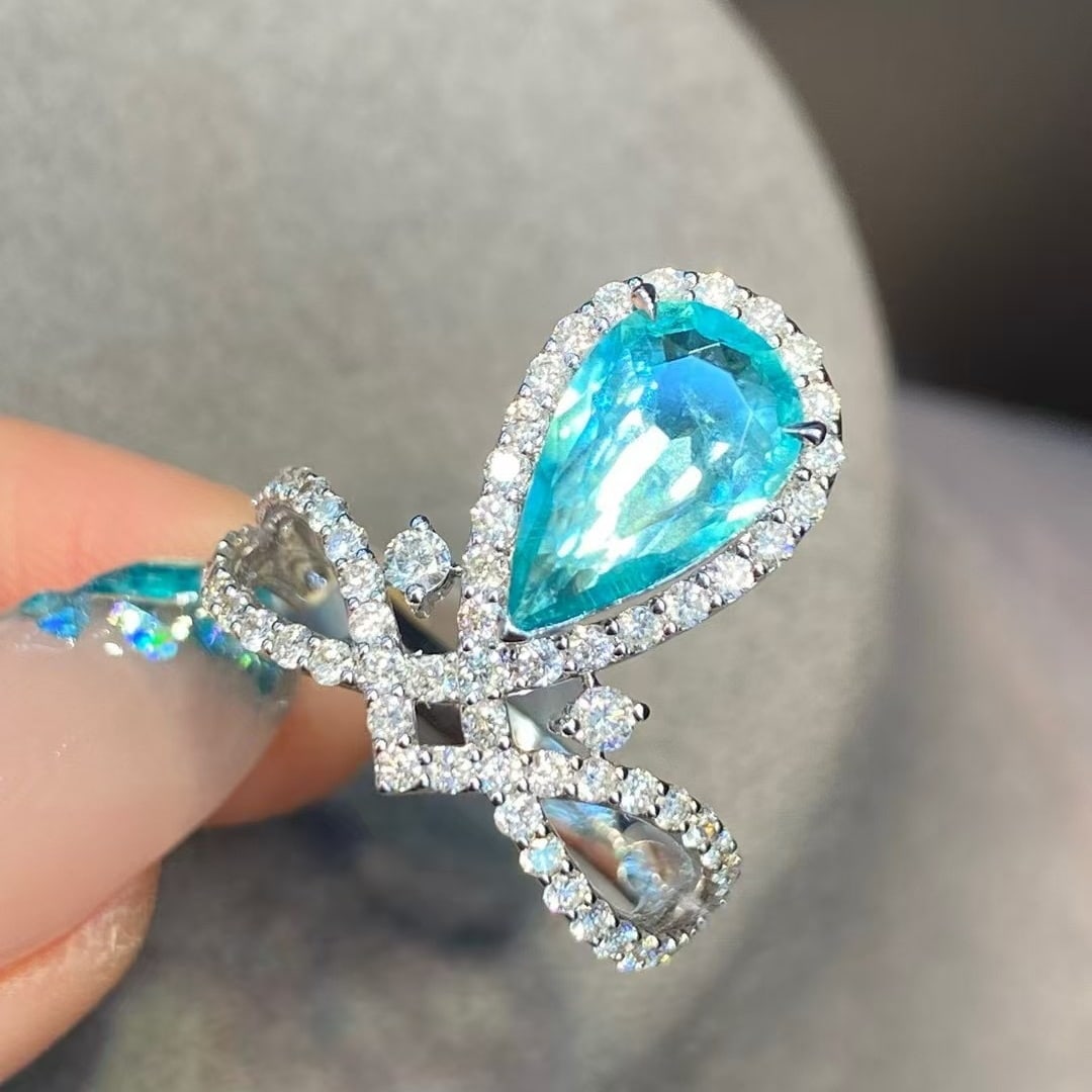 14k Gold 2.55 Ctw Natural Paraiba Tourmaline & Diamond Ring: Ref:230982298 / / gold content:14k gold / / ring size:7. 25us / / / / main gemstone:paraiba tourmaline / / shape:pear / / carat weight:1. 66ct / / color:blue / / treatment:natural / / / / adjacent