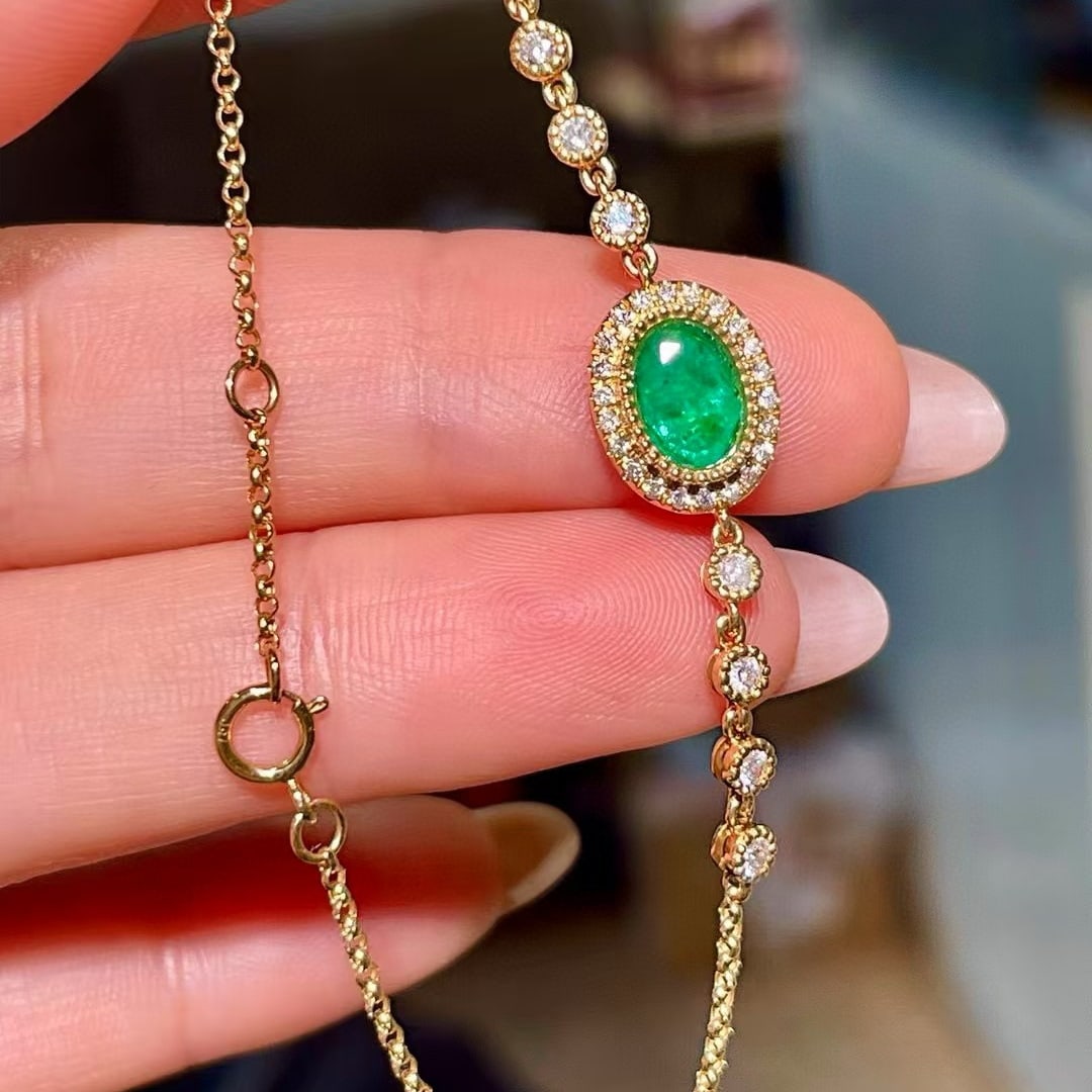 14k Gold 1.03 Ctw Natural Emerald & Diamond Bracelet: Ref:230979130 // gold content:14k gold // main gemstone:emerald // shape:oval // carat weight:0. 70ct // color:green // treatment:natural // cut grade:g // // adjacent gemstone 2 : diamond // shape:ro