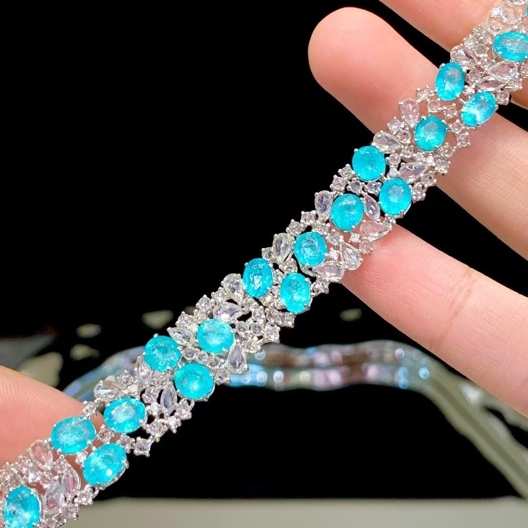 14k Gold 12.6 Ct Natural Paraiba Tourmaline & Diamond & Sapphire Bracelet: Ref:230980068 // gold content:14k gold // main gemstone:paraiba tourmaline // shape:oval // carat weight:12. 6ct // color:neon blue // treatment:natural // // adjacent gemstone 2 : diamond //
