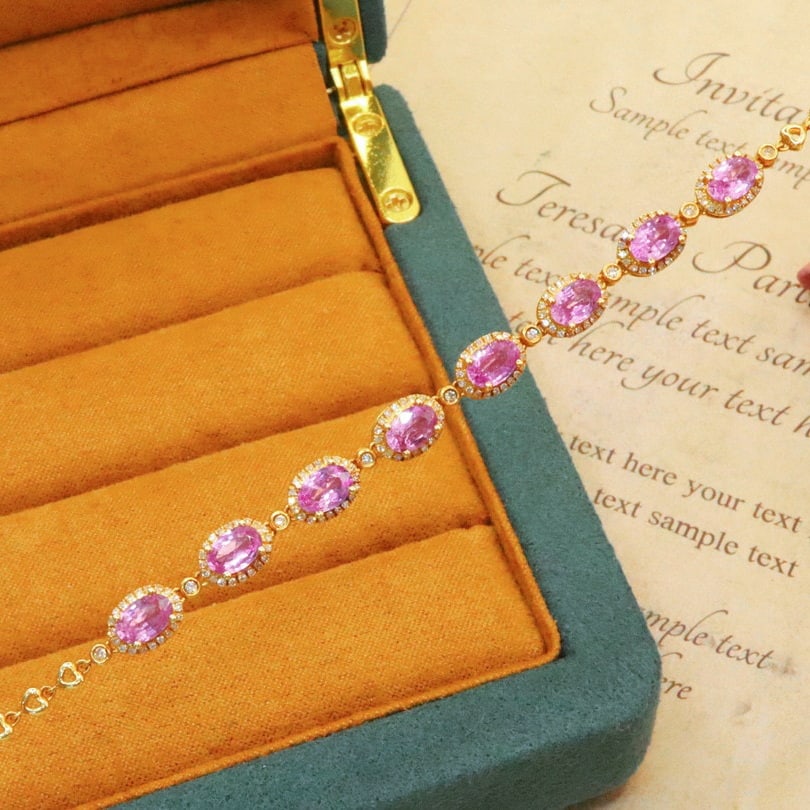 14k Gold 5.07 Ctw Natural Padparadscha Sapphire & Diamond Bracelet: Ref:230980110 // gold content:14k gold // main gemstone:padparadscha sapphire // shape:oval // carat weight:4. 50ct // color:orangish pink // treatment:natural // // adjacent gemstone 2 : diamond // n
