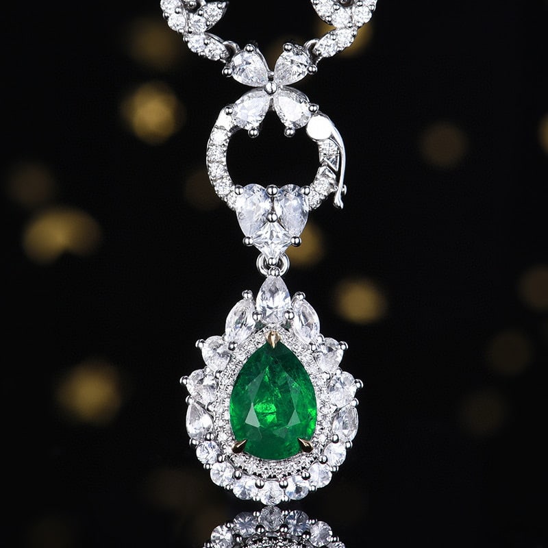 14k Gold 2.50 Ctw Vivid Green Natural Emerald & Sapphire Pendant( Without Chain ): Ref:230980188 // gold content:14k gold // main gemstone:emerald // shape:pear // carat weight:1. 28ct // color:vivid green // treatment:natural // // adjacent gemstone 2 : sapphire // number of stones