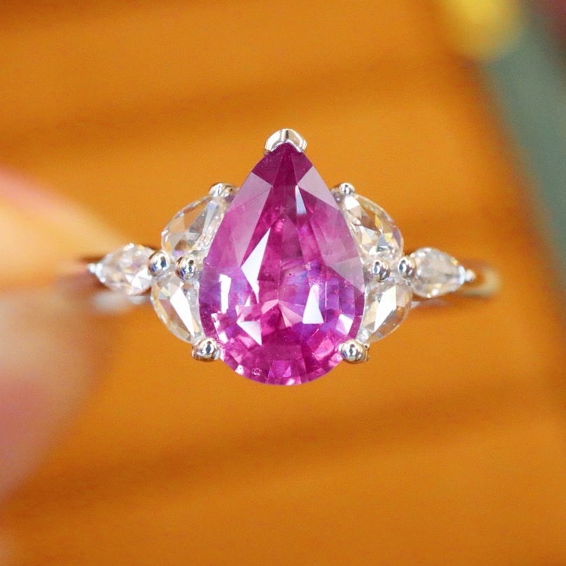 14k Gold 1.22 Ctw Natural Sapphire & Diamond Ring: Ref:230980205 // gold content:14k gold // ring size:7. 25us // // main gemstone:sapphire // shape:pear // carat weight:1. 06ct // color:pink // treatment:natural // // adjacent gemstone 2 : diamond